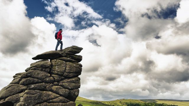 Man overcoming obstacles to reach the top