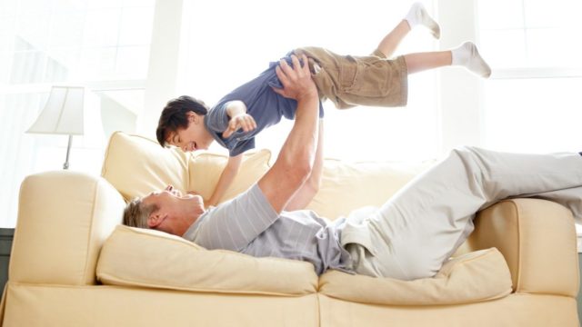 Son plays in the security of his father's arms