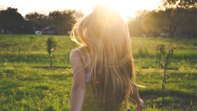 Woman in field with the optimism of the future