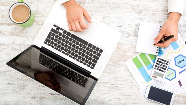 Man sitting at a table doing tax calculations