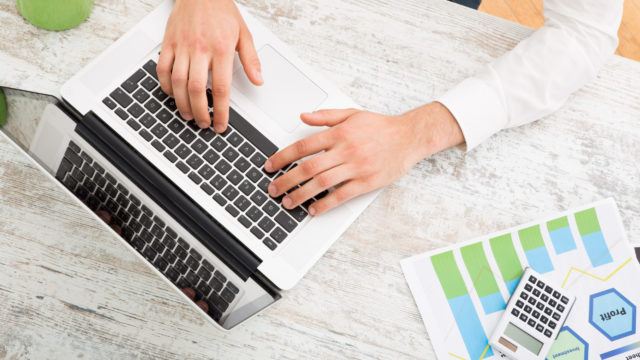 Man sitting at a table doing tax return