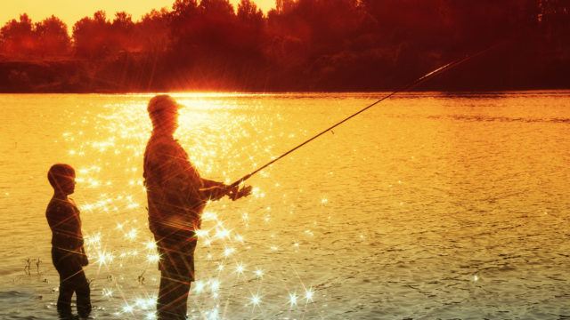 Pensioner fishing with grandchild