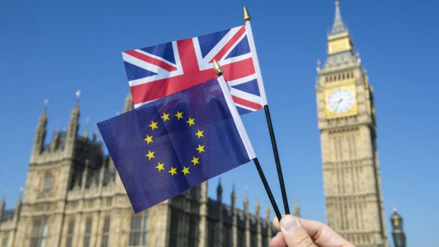 European Union and British Union Jack flag flying in front of Big Ben and the Houses of Parliament at Westminster Palace, London, following Brexit EU referendum