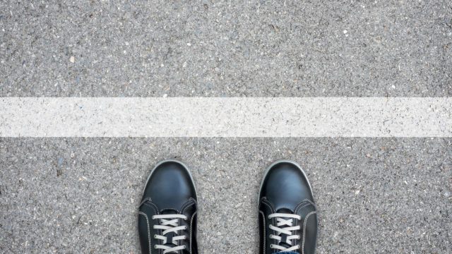 Black casual shoes standing at the white line