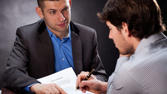 Dishonest businessman convincing his client to sign a contract