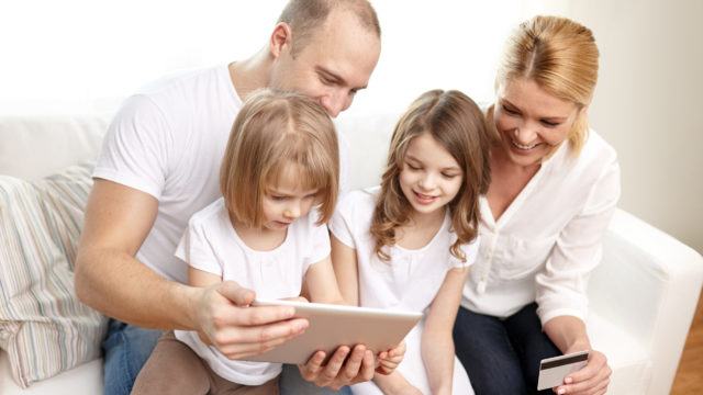 Happy family with tablet PC and credit card