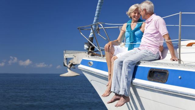 Happy Senior Couple Sitting on a Sail Boat