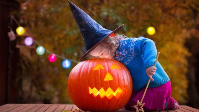 Kids carving pumpkin at Halloween