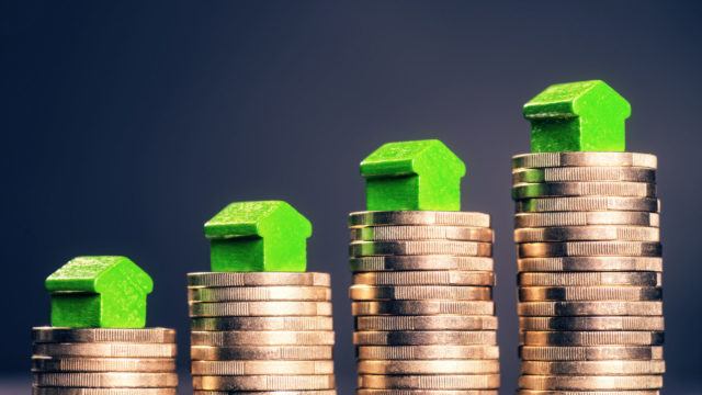 Stacks of coins with houses symbolising increased costs