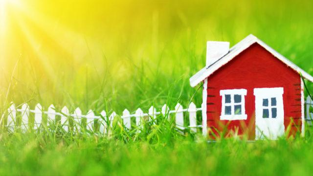 red wooden house on the grass