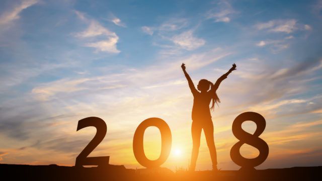 Silhouette of happy woman with New yeay 2018 concept in sunset background.