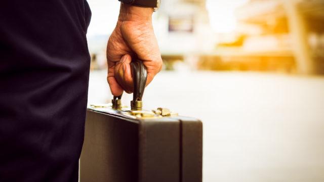 hand carrying a briefcase