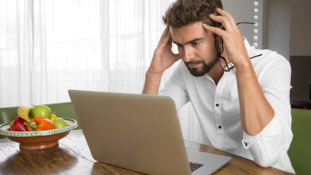 Surprised man reading bad news