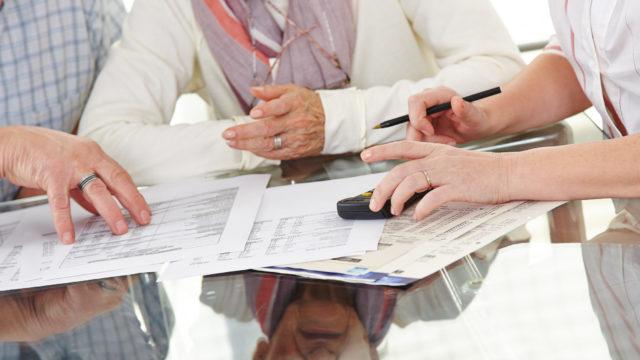 Senior couple discussing with financial consultant