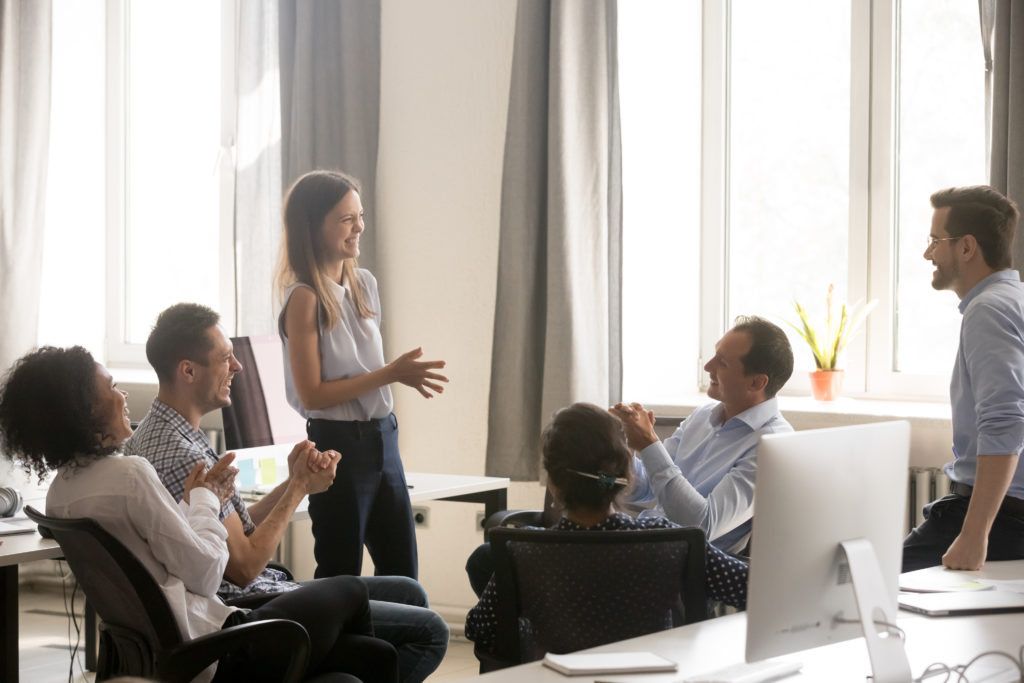 Young female coach, leader having fun with employees, office wor