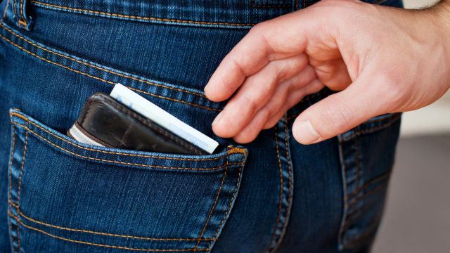 pickpocket trying to steal wallet from back pocket