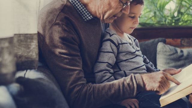 grandparent reading to boy