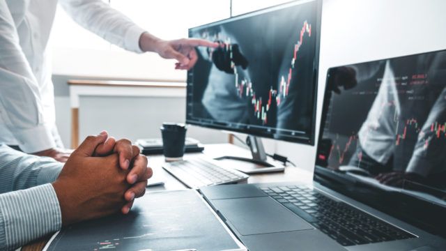 businessmen looking at graph