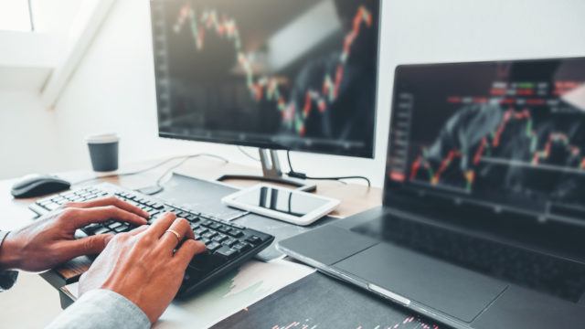 person looking at stock market graph on their computer