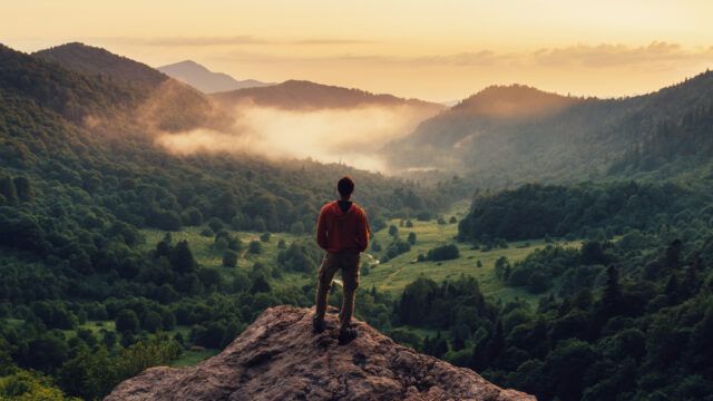 man standing on a mountain peak