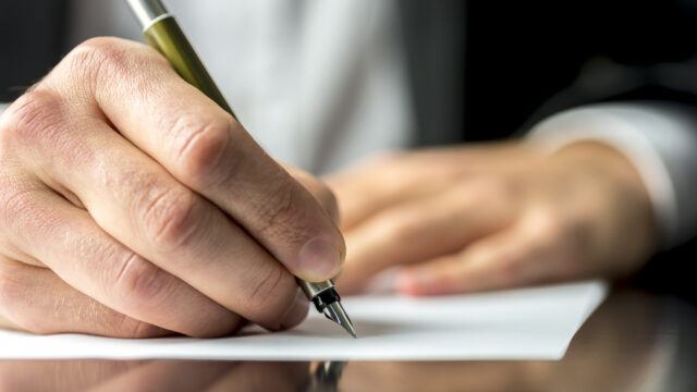 man writing a letter