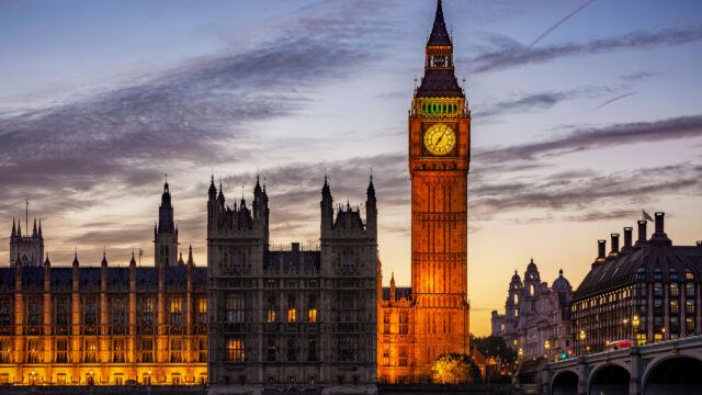 An external image of the Palace of Westminster in the evening