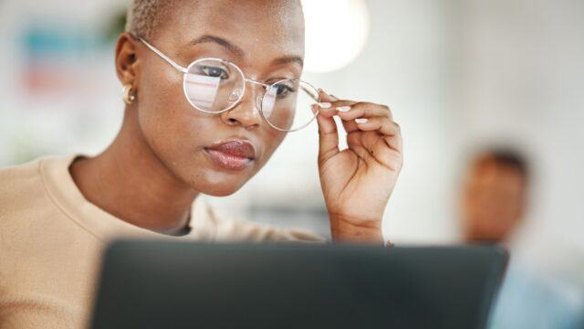 woman reading from her laptop