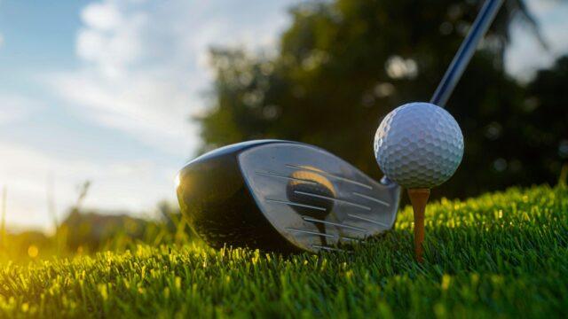 close-up shot of a golf club and ball on a golf course