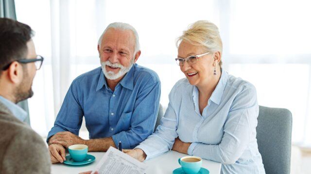 As Inheritance Tax investigations soar, here’s how to avoid HMRC scrutiny Senior couple in a meeting with their financial planner